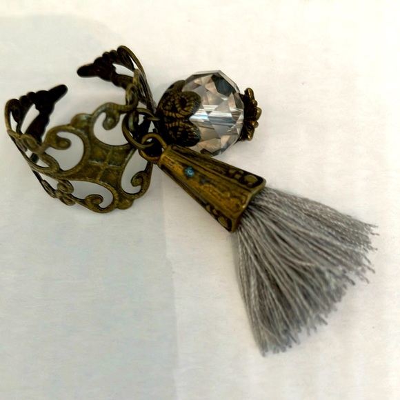 ADJUSTABLE Ring. VERY THIN METAL BRONZE-LOOK RING. Grey Tassel. Clear Babble. - Picture 1 of 1